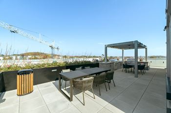 A roof terrace with tables and chairs and a pavilion